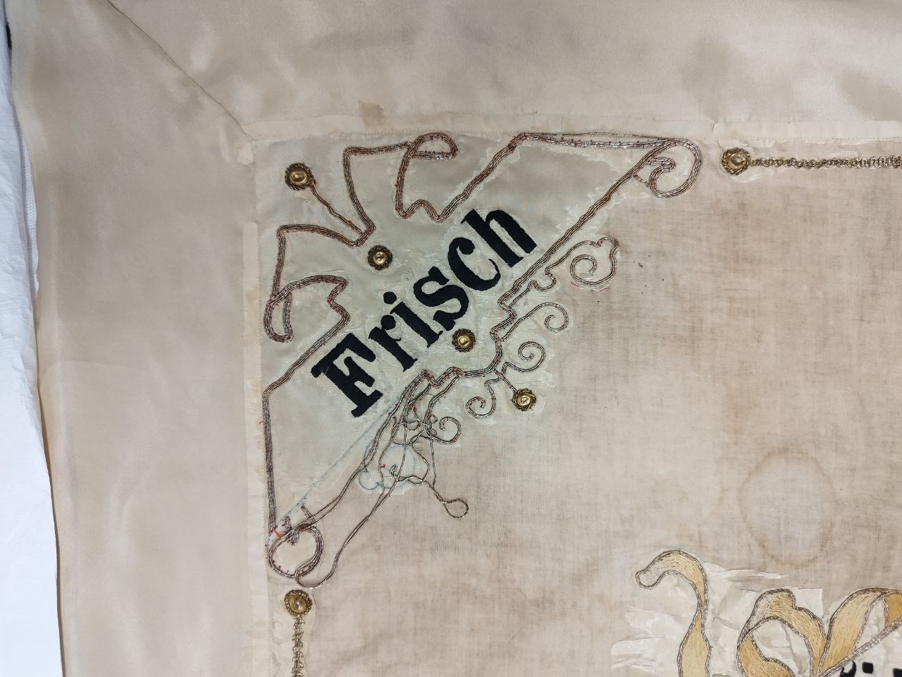 Detailbild Frisch mit teilweise wieder angenähtem Metalllahn